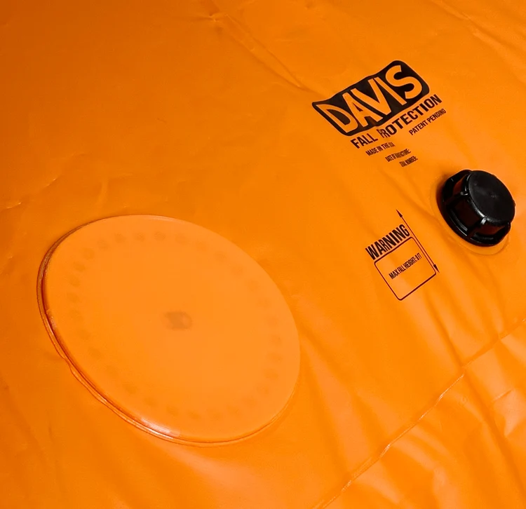 Circular orange pressure relief cover on a Davis fall protection bag